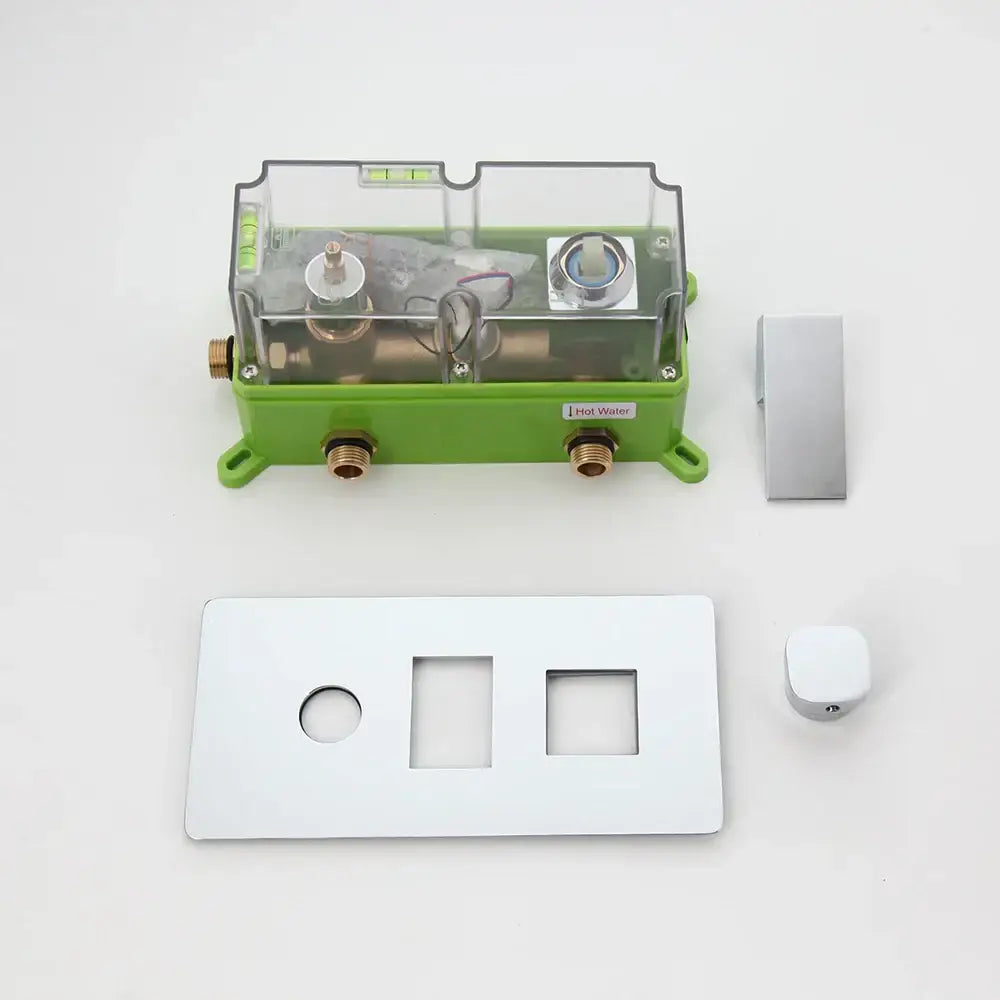 Green plastic housing with transparent cover showing brass plumbing labeled hot water for shower mixer valve control panel