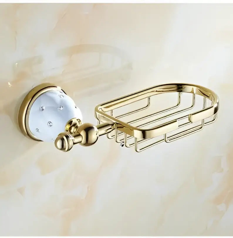 Gold-finished metal soap dish with white ceramic knob and clear crystals in chrome and gold decorbites bathroom hardware set