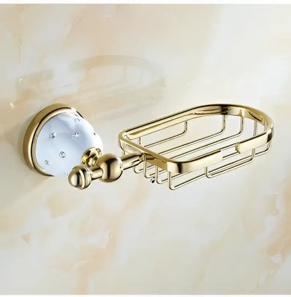 Gold-finished metal soap dish with white ceramic knob and clear crystals in chrome and gold decorbites bathroom hardware set