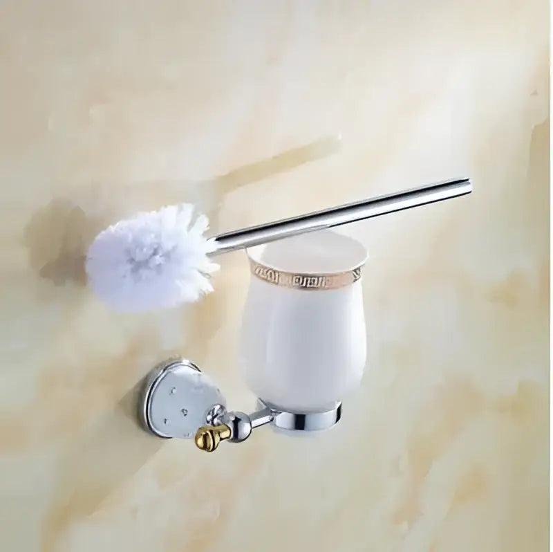 White ceramic toilet brush holder with gold trim and chrome wall mount from decorbites bathroom hardware set