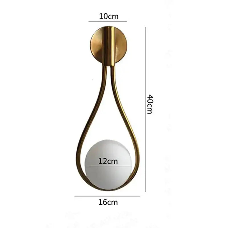 Gold-toned teardrop wall sconce with mirrored spherical center and circular base ideal for bedroom decorbites black glass ball