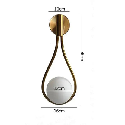 Gold-toned teardrop wall sconce with mirrored spherical center and circular base ideal for bedroom decorbites black glass ball