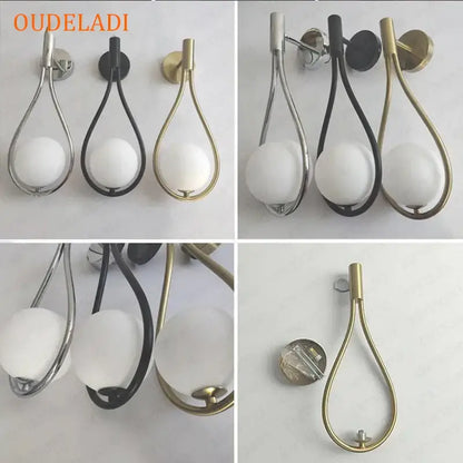 Chrome teardrop wall sconce with frosted white glass ball and decorbites black glass ball accents for bedroom decor