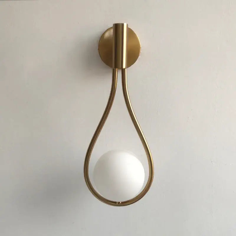 A sleek chrome teardrop wall sconce with a white black glass ball perfect for bedroom decorbites black glass decor