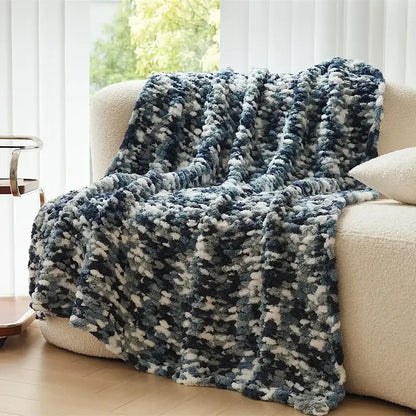 A cozy chunky knit jacquard blanket throw in navy blue and cream mottled blend for living room decor