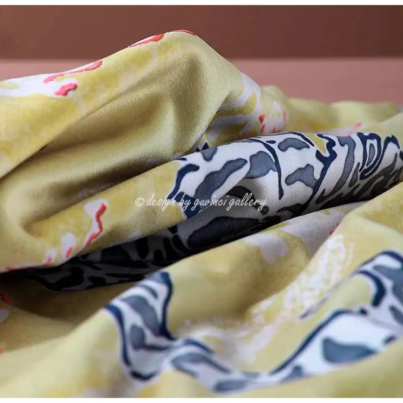 A soft yellow floral fabric layered over black and white contrasts on decorbites circus horse print blue velvet cushion cover