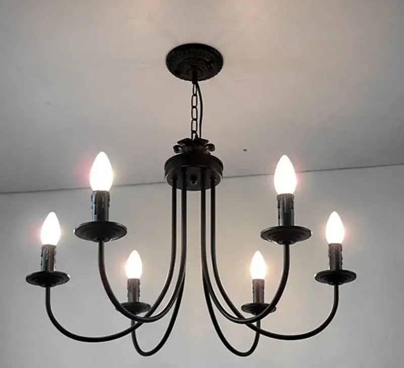 Classic black curved arm chandelier with five candle-style bulbs in black wrought iron for dining room decorbites black curved arm lighting