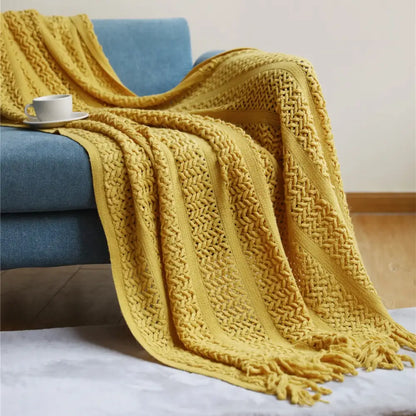 A cozy mustard-yellow knitted throw blanket with textured herringbone pattern and fringed edges for home decorbites houndstooth throw