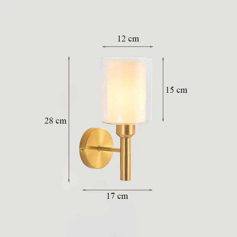 Gold-finished brass glass wall sconce with cylindrical frosted shade for bedroom decorbites brass glass lighting