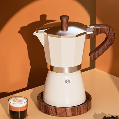 Cream-colored classic coffee machine moka pot with wooden handle and metallic bands for kitchen coffee brewing