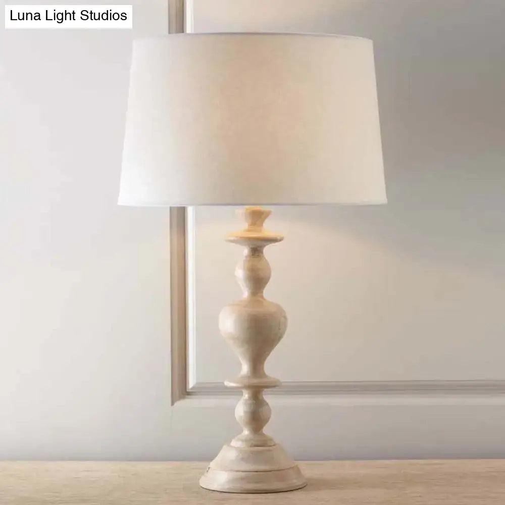 Cream-colored decorbites™ nightstand lamp with distressed wood resin base and white fabric tapered shade for led use 220v-240v