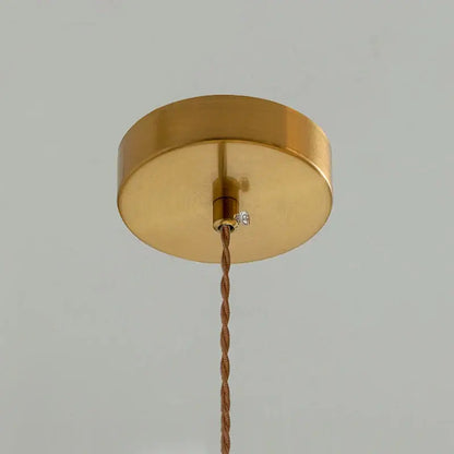 Gold-colored circular ceiling light fixture with twisted copper cable for classic glass flower pendant light brass hardware