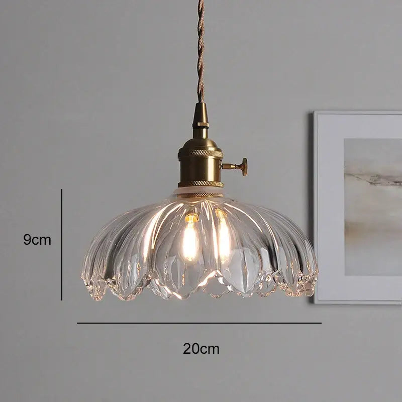 Classic glass clear ribbed pendant light with brass hardware and twisted cord for elegant dining room use