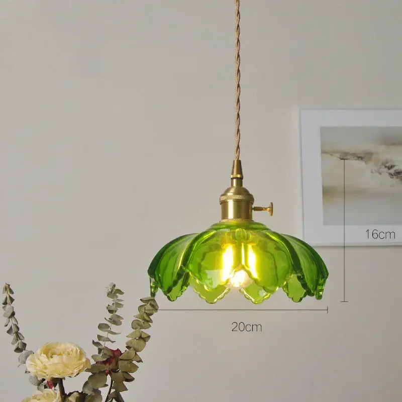 Classic green glass pendant light with brass hardware and twisted cord ideal for dining room lighting