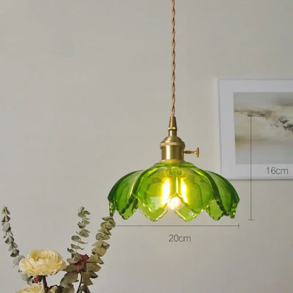 Classic green glass pendant light with brass hardware and twisted cord ideal for dining room lighting