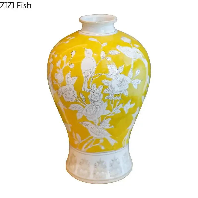 A vibrant yellow ceramic vase with delicate white bird and floral motifs, suitable for decorbites blue and white porcelain decor