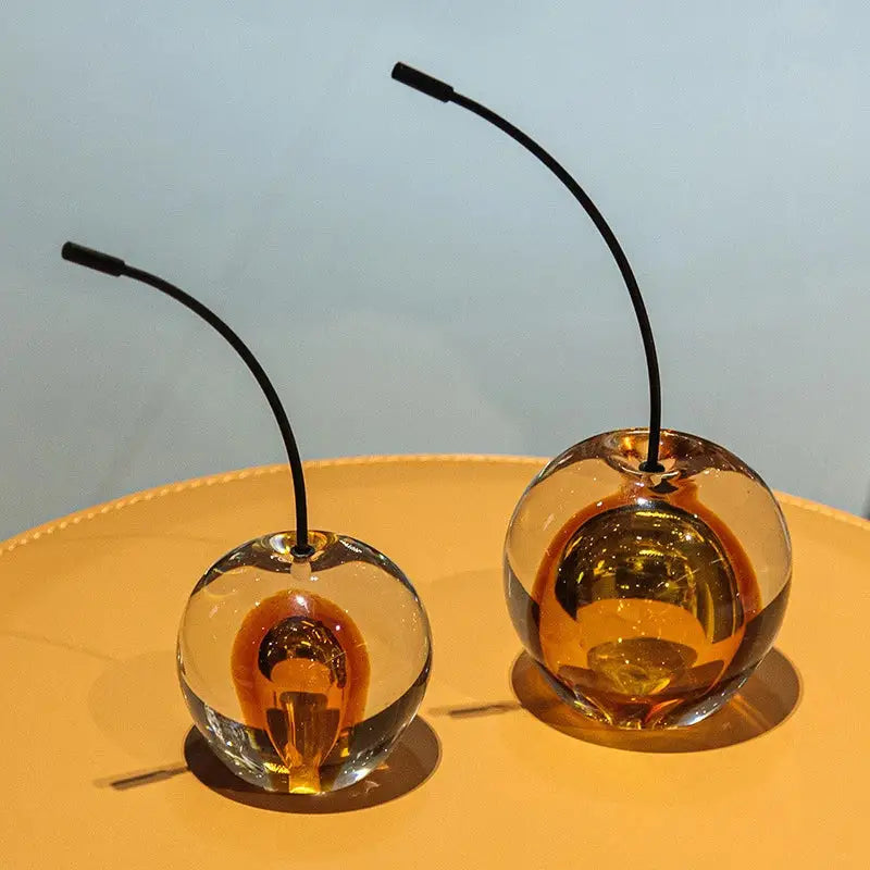 Two amber glass cherry sculpture ornaments with black stems for clear and gold crystal cherry decorbites decor