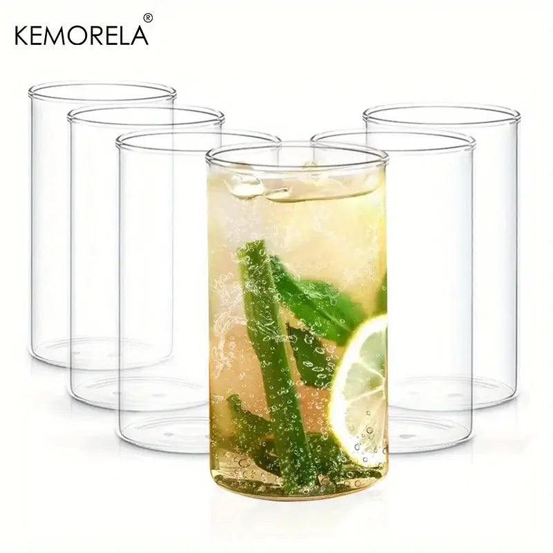 Clear borosilicate drinking glass filled with refreshing beverage garnished with mint and lime in drinking glasses set