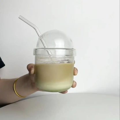 Clear glass bobo cup with ribbed lid and curved straw filled with light green beverage from decorbites clear glass set