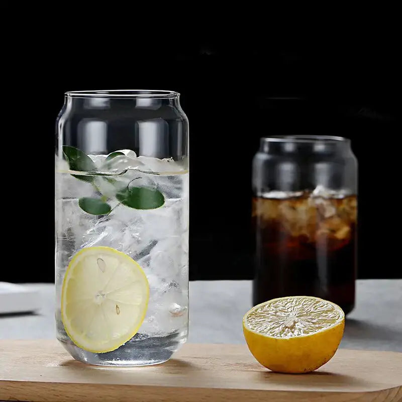 Clear glass drink cup with bamboo lid and straw filled with ice lemon slice and green leaves for decorbites glass drink use