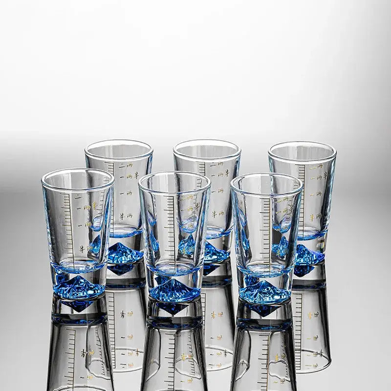Clear glass liquor cup set with blue crystal-like bases and gold measurement markings for decorbites clear glass