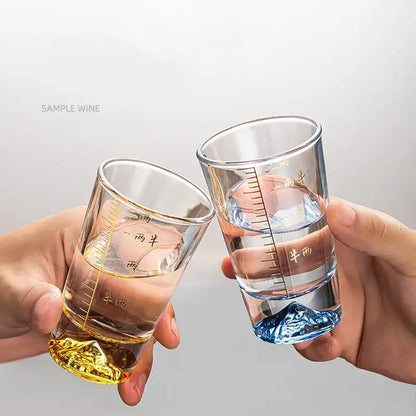 Clear glass liquor cup set with gold measurement markings and colorful mountain-shaped textured bases by decorbites clear glass