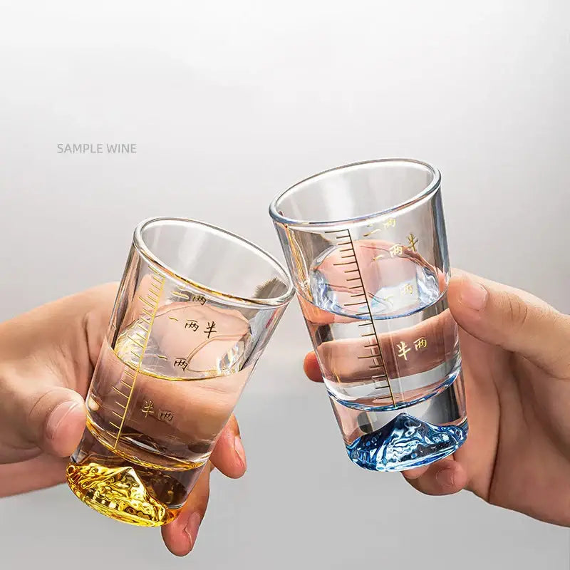 Clear glass liquor cup set with gold measurement markings and colorful mountain-shaped textured bases by decorbites clear glass