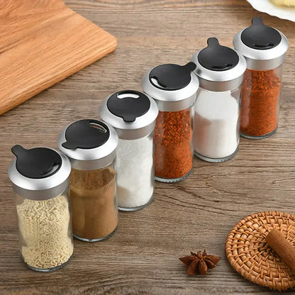 Set of five clear glass rotating spice jars with silver lids and black flip-top caps for spice jar seasoning decorbites rotating spice