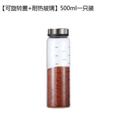 Clear glass spice shaker with rotary lid filled with red pepper flakes for salt sesame pepper storage