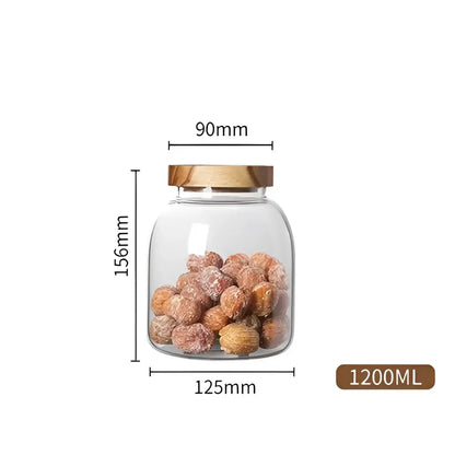 Clear kitchen glass jar with acacia lid filled with dried fruit for food storage in kitchen glass jars set of 2