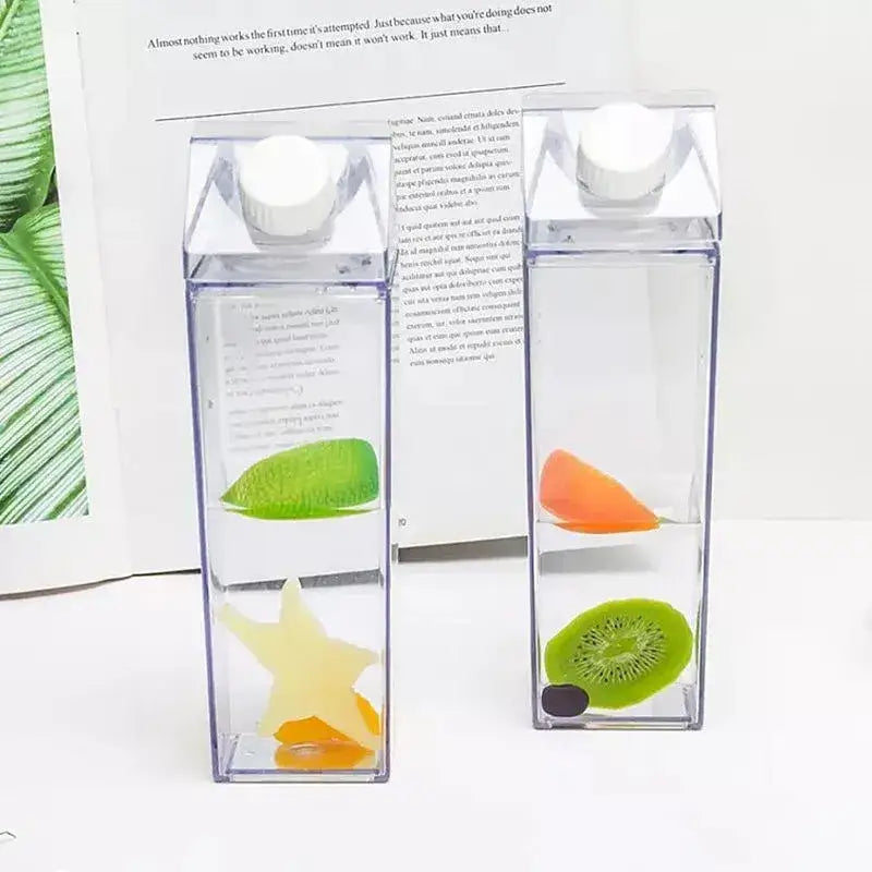 Clear milk carton water bottle set with transparent square design and colorful fruit slices in clear liquid for kitchen storage