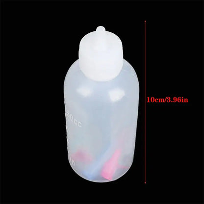 Transparent plastic squeeze bottle with white rounded cap and measurement markings for decorbites cake decor use