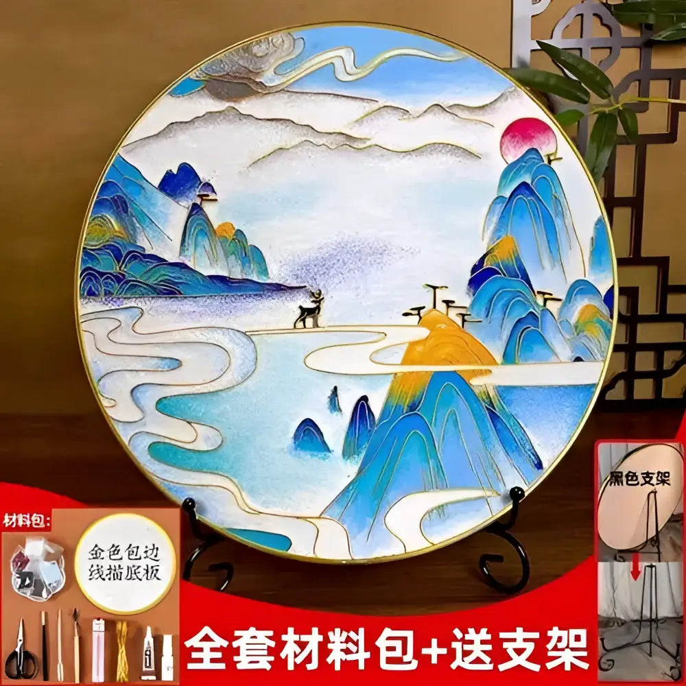 A circular ceramic plate with hand-painted blue and green landscape design from decorbites cloisonne silk enamel diy kit