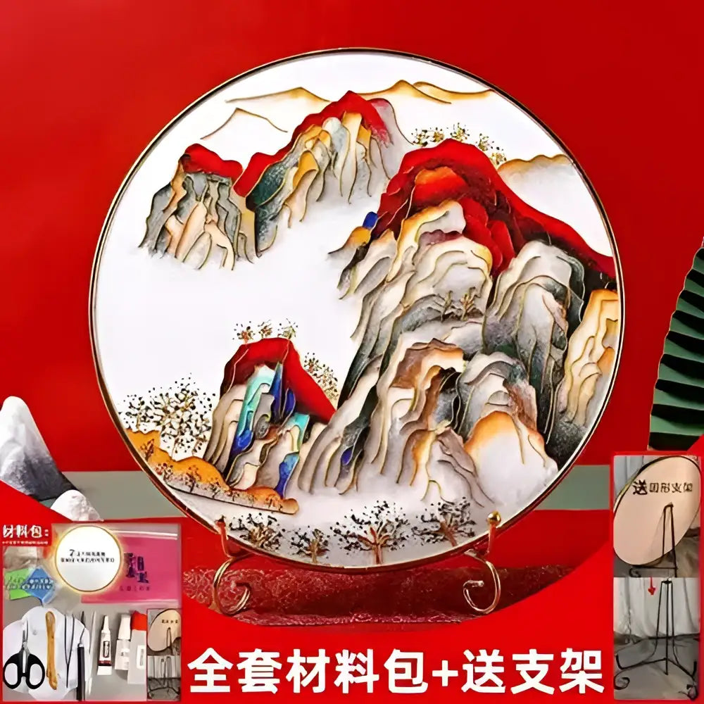 A circular porcelain plate with hand-painted red gold and green mountains in a decorbites cloisonne silk enamel diy kit
