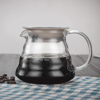 Clear glass coffee kettle with silver lid and measurement markings filled with dark brewed coffee from decorbites cloud shaped glass collection