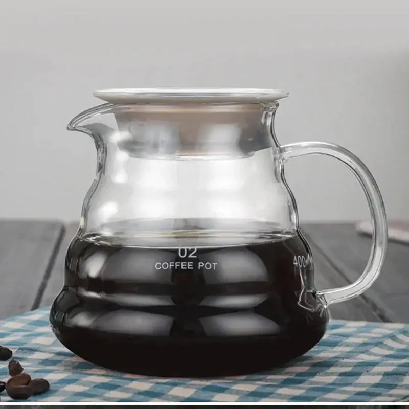 Clear glass coffee kettle with silver lid and measurement markings from decorbites cloud shaped glass collection