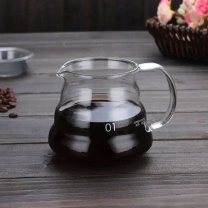Clear glass coffee kettle with curved handle and spout filled with dark brewed coffee decorbites cloud shaped design