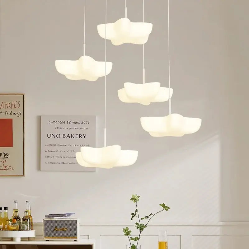 Cloud white modern chandelier with smooth matte finish pendant lights hanging over kitchen island decorbites cloud white