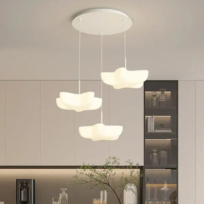 Three white cloud shaped pendant lights hang from a circular ceiling fixture in the decorbites cloud white modern chandelier