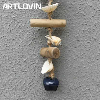 A rustic coastal blue and white drift wood bells ornament featuring bamboo, seashells, and a navy blue bell hanging decor