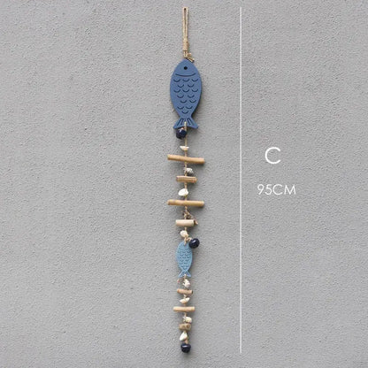 Coastal blue wooden fish drift wood bells with natural wood sticks seashells and dark beads living room wall decor