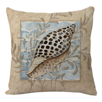 Beige decorbites coastal cushion cover featuring black-spotted seashell embroidery on blue ocean seaweed backdrop