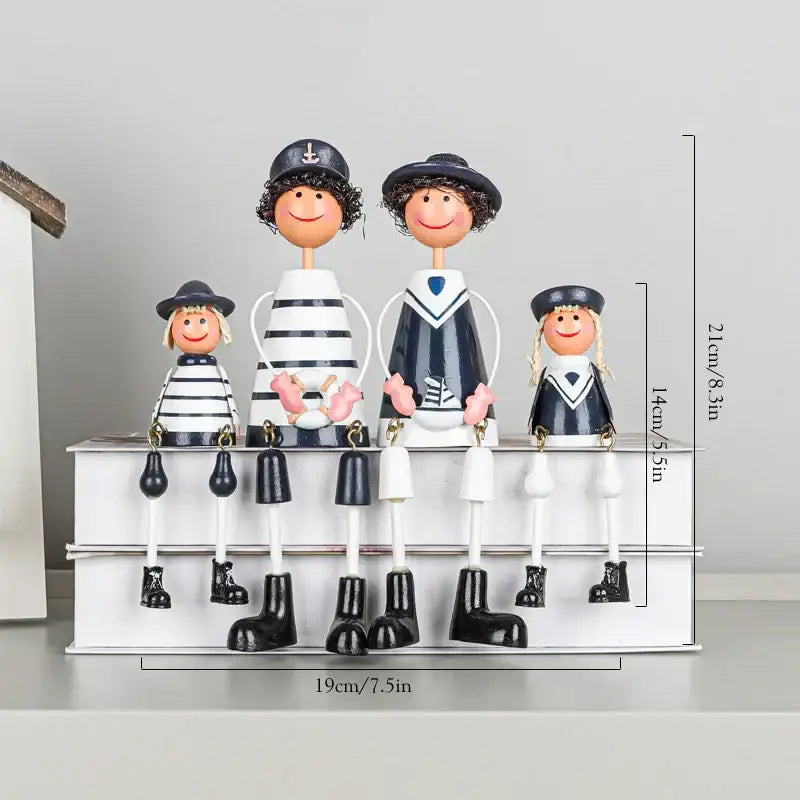 A charming black and white nautical-themed family figurine set displayed with coastal wooden ship model decorbites decor