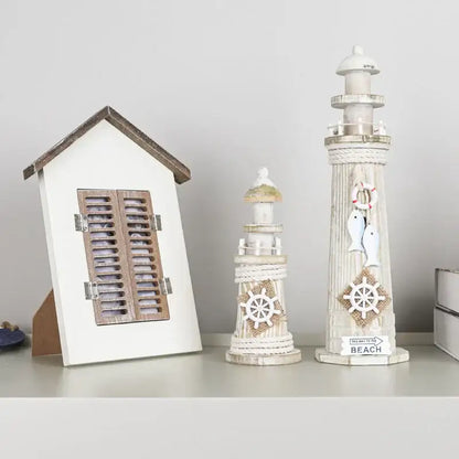White painted coastal wooden lighthouse ornament with rope detailing and nautical decorbites coastal wooden ship model