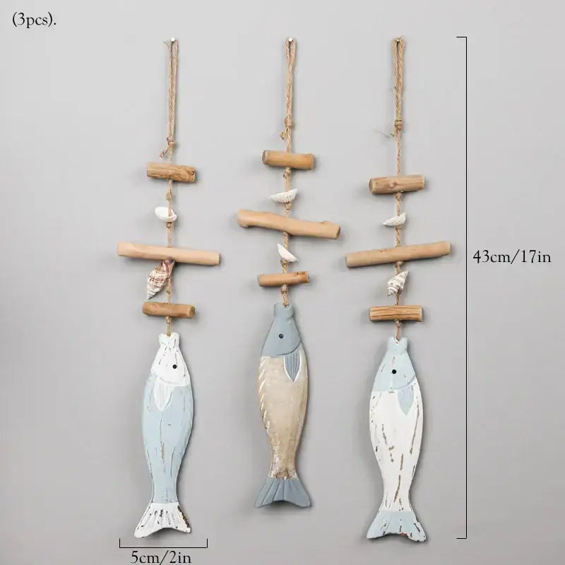 Three rustic wooden fish wall hangings with faded blue and white distressed finishes and seashells for decorbites coastal wooden decor