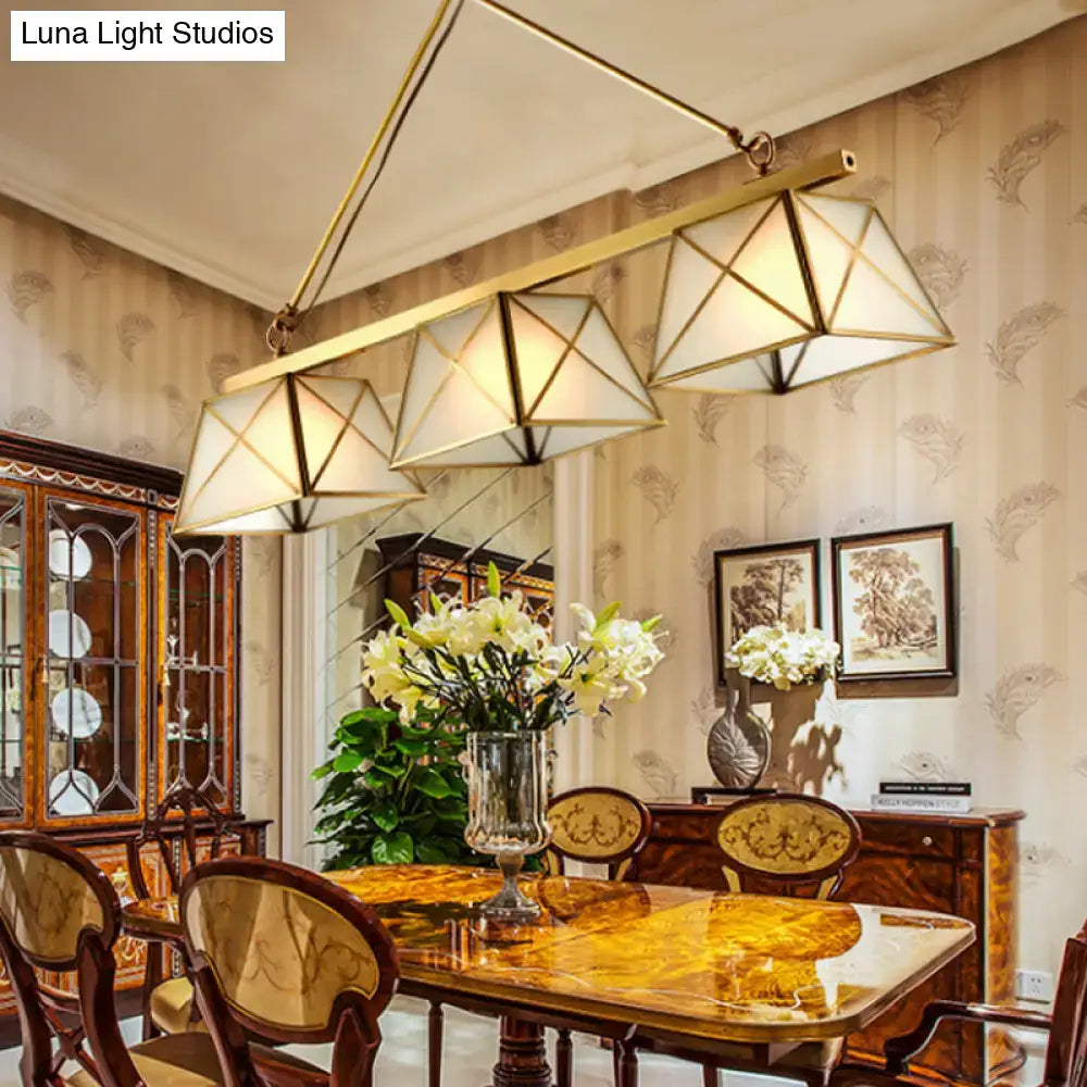 Gold-toned colonial style pendant light with tapered island design and geometric triangular shades in brass finish