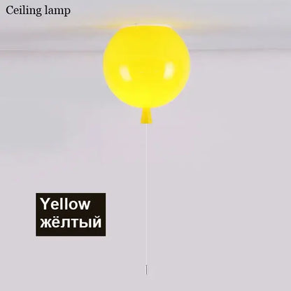 A bright yellow balloon ceiling sconce lamp with a glossy finish and a thin white cord for bedroom decor