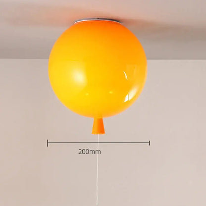 Vibrant orange spherical ceiling sconce lamp with glossy finish and tapered base for colorful bedroom decor