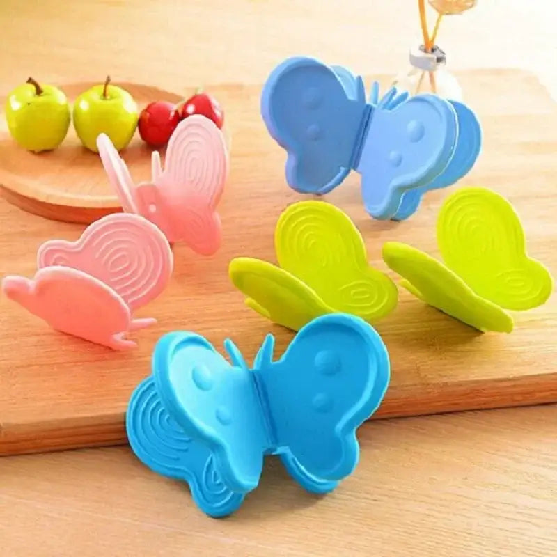 Colorful butterfly silicone insulation plate clamps in pink blue and lime green for kitchen use by decorbites butterfly silicone