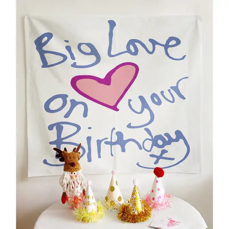 White fabric wall tapestry with blue cursive big love on your birthday text and pink heart decorbites birthday wall decor